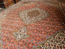 Load image into Gallery viewer, Large Vintage Hand-Knotted Wool Rug – Geometric Medallion & Floral Border – 7'1" × 5'