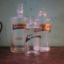 Load image into Gallery viewer, Antique Apothecary Bottle Trio With Stoppers, Original Pharmacy Labels, Clear Glass Chemist Jars, Tallest 25 cm (9.84")
