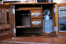 Load image into Gallery viewer, 1920s Oak Drinks /Smokers Cabinet – Glass Fronted – Cut Glass Decanter – Inscribed Presentation Piece – 39cm