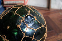 Load image into Gallery viewer, Antique British Glass Fishing Float with Net — “FGC” Maker’s Mark (Forsters Glass Co.), c. 1920–40
