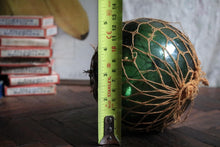 Load image into Gallery viewer, Antique British Glass Fishing Float with Net — “FGC” Maker’s Mark (Forsters Glass Co.), c. 1920–40
