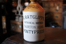 Load image into Gallery viewer, 26cm Stoneware Ginger Beer / Botanical Brewer Bottle — R. Ratcliffe, Thurston Road, Pontypridd, Two-Tone Advertising, c.1890–1910
