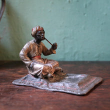 Load image into Gallery viewer, Cold-Painted Spelter Bergman Style Figure – Turbaned Pipe Smoker on Carpet Tray
